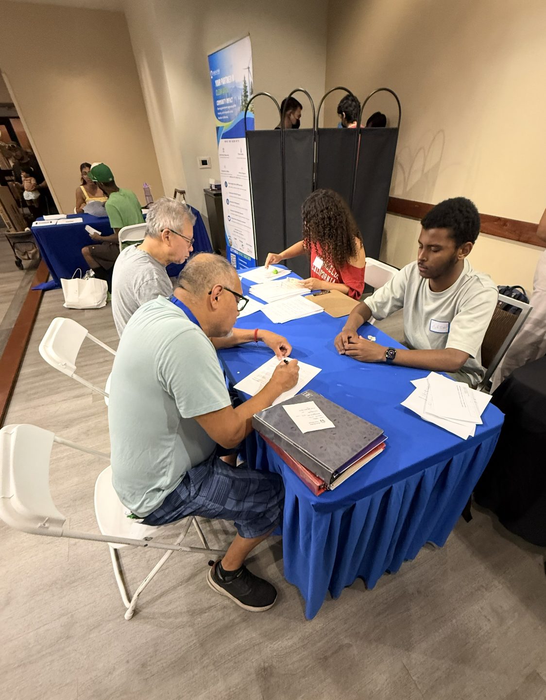 A patient completing an intake questionnaire at a screening event